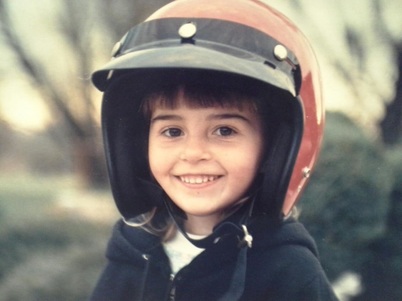 Picture of Stephanie Irvine, freelance copywriter and content writer, as a child wearing a helmet that is way too big.